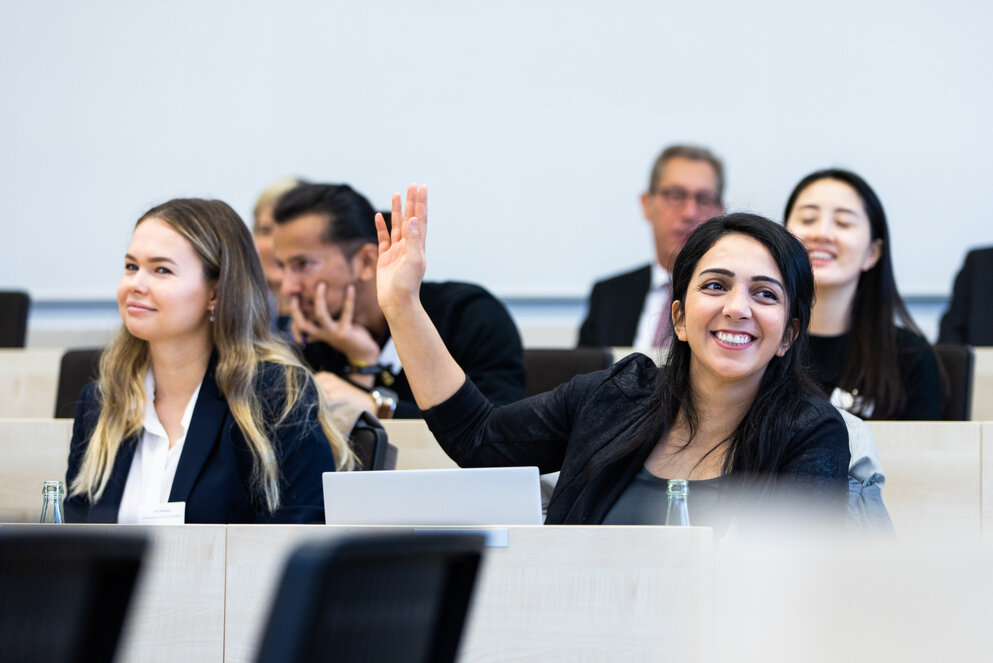 Students in a classroom ask questions about the MBA