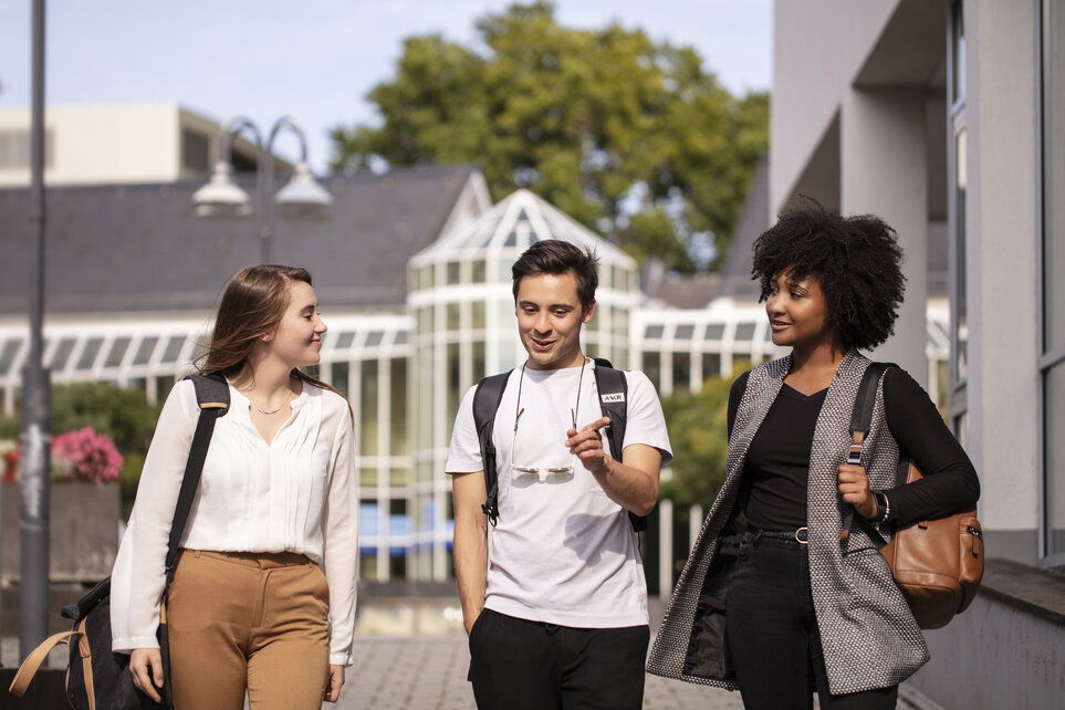 Three young people walking outside and talking